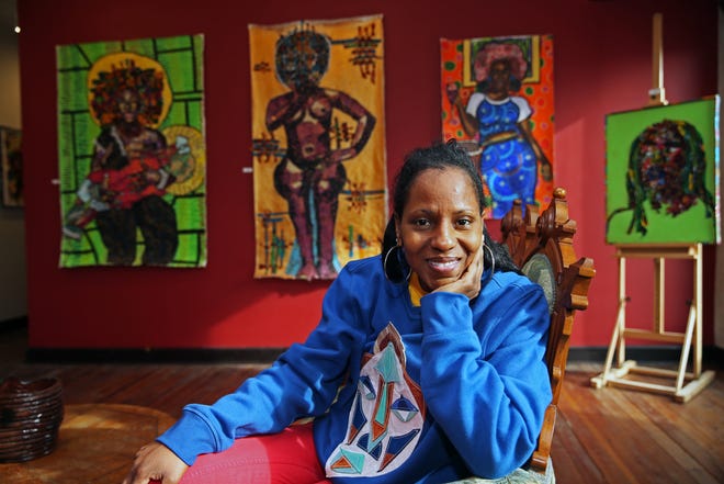 Owner and curator, Fatima Laster is photographed with Zsudayka Nzinga exhibit titled “all the pieces we leave behind” that is on display at 5 Points Art Gallery & Studios on Tuesday, Feb. 1, 2022. The show runs through Feb. 26, 2022.