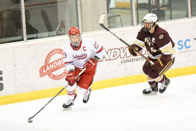 St. John's senior Auggie Moore passes the puck Thursday, Feb. 3, 2022, at Herb Brooks National Hockey Center in St. Cloud. 