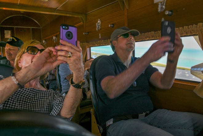 Karen Bartz (left) and Craig Cuthrell, both of Stuart, record the start of their flight above Stuart as passengers inside the Ford Tri-Motor 5-AT airplane, leased by the Experimental Aircraft Association, during a tour of the airplane on Thursday, Feb.3, 2022, at Witham Field in Stuart. 