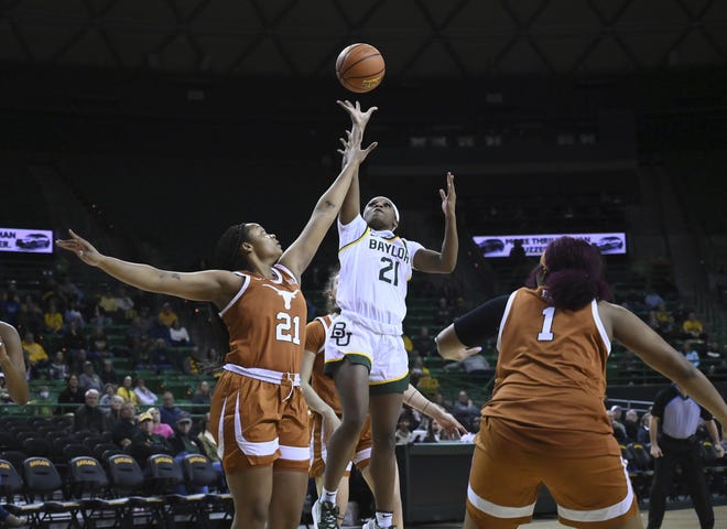 Baylor guard Ja'Mee Asberry scores over Texas forward Aaliyah Moore in the first half Friday night.