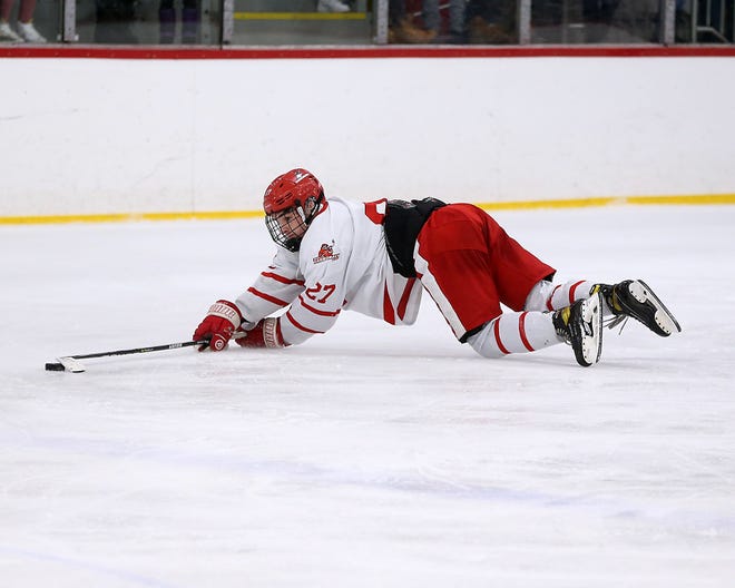 Hingham's Ace Concannon dives for the puck after getting tripped during third period action of their game against Pope Francis at Pilgrim Arena on Saturday, Feb. 5, 2022.
