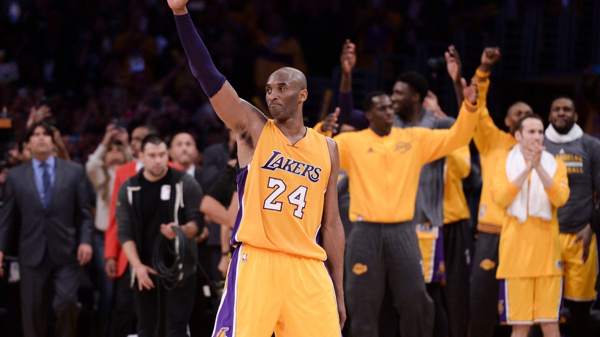 Kobe Bryant waves to the crowd as he heads to the bench during the final game of his career against the Jazz.