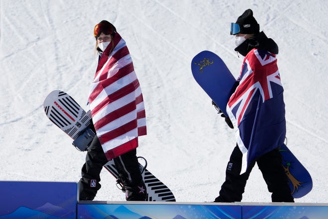 Silver medalist Julia Marino and gold medalist Zoi Sadowski-Synnott walk to the podium following the women's slopestyle snowboarding final.