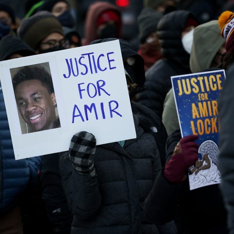 A protester holds a sign demanding justice for Ami