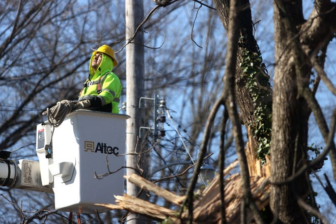 Private contractors remove a fallen tree from the roof of a house in Orange Mound Monday, Feb. 7, 2022 days after a winter storm toppled trees and power lines, leaving nearly 140,000 MLGW customers without electricity.