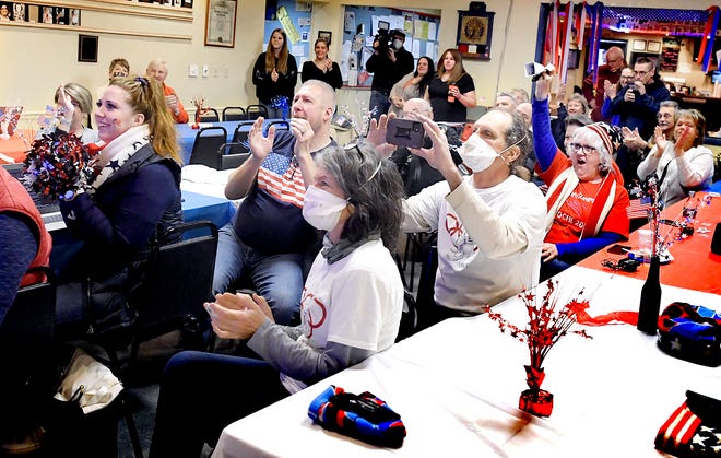 A crowd cheers for Susquehannock High School graduate Summer Britcher while watching a broadcast as she begins her first run of the women's luge competition at the Beijing Winter Olympic Games Monday, Feb. 7, 2022. About 25 people attended the event, at American Legion Post 403 in Glen Rock, to watch Britcher compete in her third Olympics. Bill Kalina photo