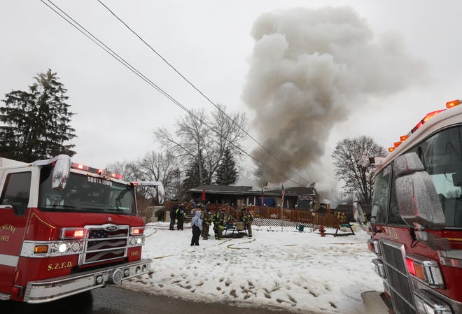 Smoke pours from 112 S. Willow Drive in Springfield Township Thursday. Two perished in the fire, and the South Zanesville Fire Department is raising funds for the survivors.