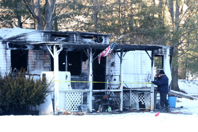 An investigator with the State Fire Marshal's Office tapes off a mobile home near Gaysport that was destroyed by fire on Monday. A male was recovered from the home, which was a total loss, according to Wayne Township Fire Chief Don Alexander. The incident remains under investigation by the State Fire Marshal and Muskingum County Coroner.