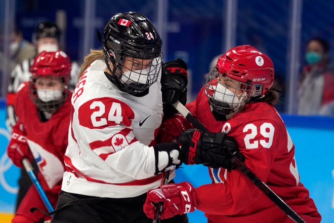 Canada's Natalie Spooner and the Russian Olympic Committee's Alexandra Vafina battle during Monday's game.