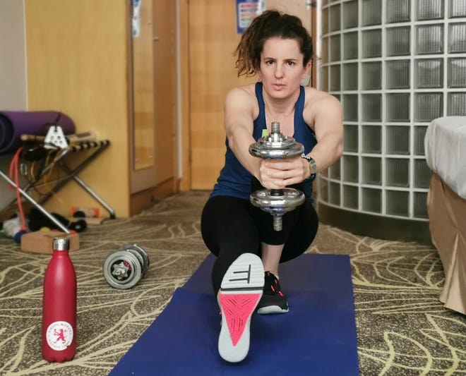 Swiss snowboarder Patrizia Kummer works out in her hotel room in Beijing on Jan. 19  under a 21-day quarantine. Kummer, who won a gold medal at the 2014 Sochi Olympics, is unvaccinated against the coronavirus, so she spent 21 days in isolation in China before the Games.