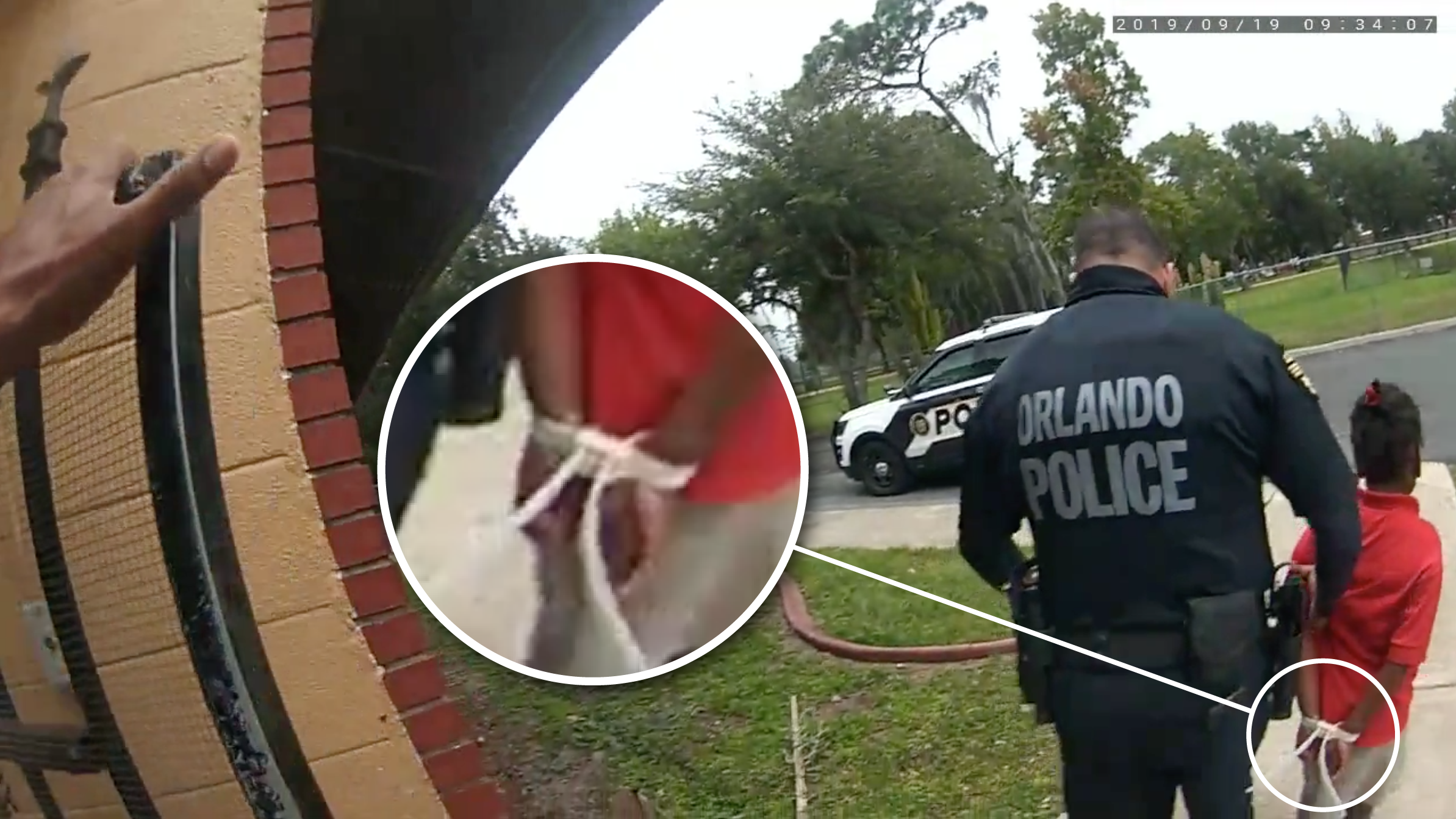 An Orlando police officer leads 6-year-old Kaia Rolle out of her school with her hands tied behind her back with zip ties.