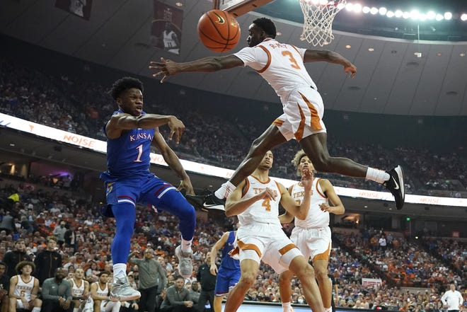 Kansas guard Joseph Yesufu (1) passes around Texas guard Courtney Ramey (3) during the first half of an NCAA college basketball game, Monday, Feb. 7, 2022, in Austin, Texas.