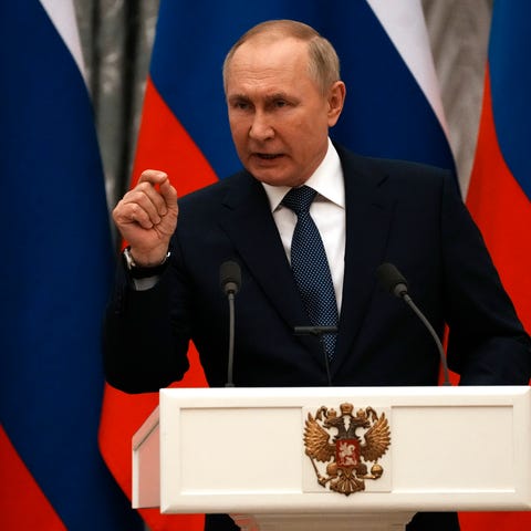 Russian President Vladimir Putin gestures during a