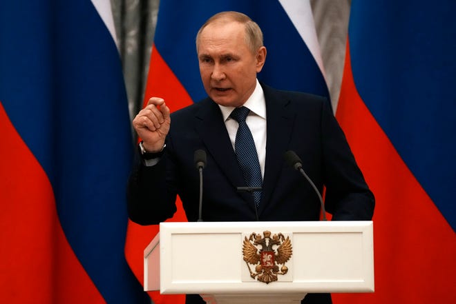 Russian President Vladimir Putin gestures during a joint press conference with French President Emmanuel Macron after their talks Feb. 7, 2022, in Moscow.