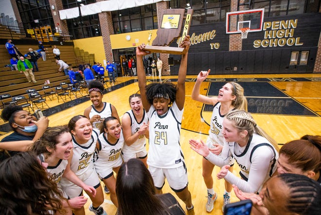 Penn senior Jada Patton hoists the sectional championship trophy after leading the Kingsmen to the title earlier this week at Penn.