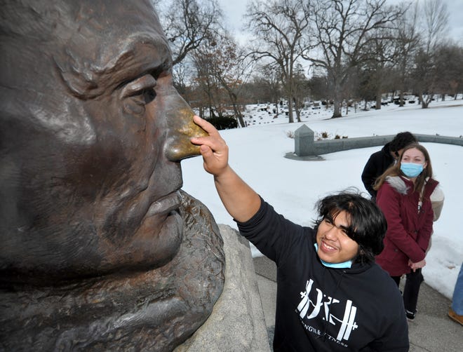 Alan Espinoza, 17, of Addison, Illinois, touches the nose of the Lincoln statue at Lincoln's grave for good luck during a trip with his high school class on Wednesday, Feb. 9, 2022. {Thomas J. Turney The State Journal Register}