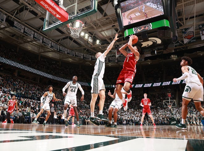 EAST LANSING, MI - FEBRUARY 08: Johnny Davis #1 of the Wisconsin Badgers shoots over Joey Hauser #10 of the Michigan State Spartans at Breslin Center on February 8, 2022 in East Lansing, Michigan. (Photo by Rey Del Rio/Getty Images