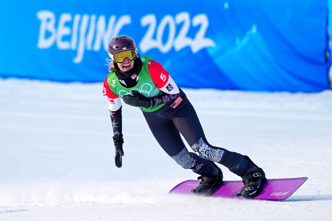 Lindsey Jacobellis celebrates winning the gold medal in women's snowboard cross during the 2022 Beijing Olympics.