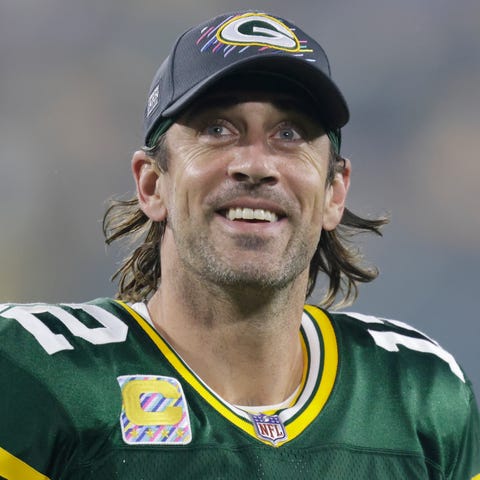 Green Bay Packers' Aaron Rodgers smiles as he leav