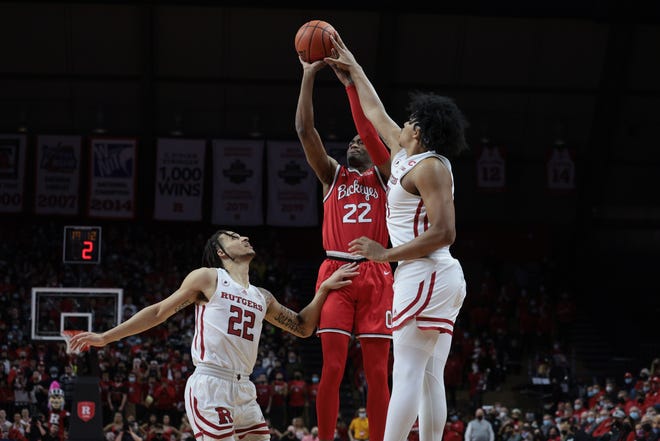 Feb 9, 2022; Piscataway, New Jersey, USA; Ohio State Buckeyes guard Malaki Branham (22) shoots the ball as Rutgers Scarlet Knights forward Ron Harper Jr. (24) and guard Caleb McConnell (22) defend during the first half at Jersey Mike's Arena. Mandatory Credit: Vincent Carchietta-USA TODAY Sports