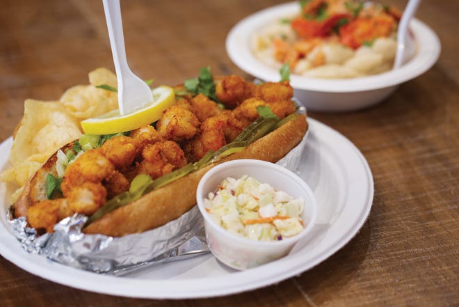 A Cajun shrimp po’boy with coleslaw and chips, and an order of lobster mac ’n’ cheese, from Coast to Local Market