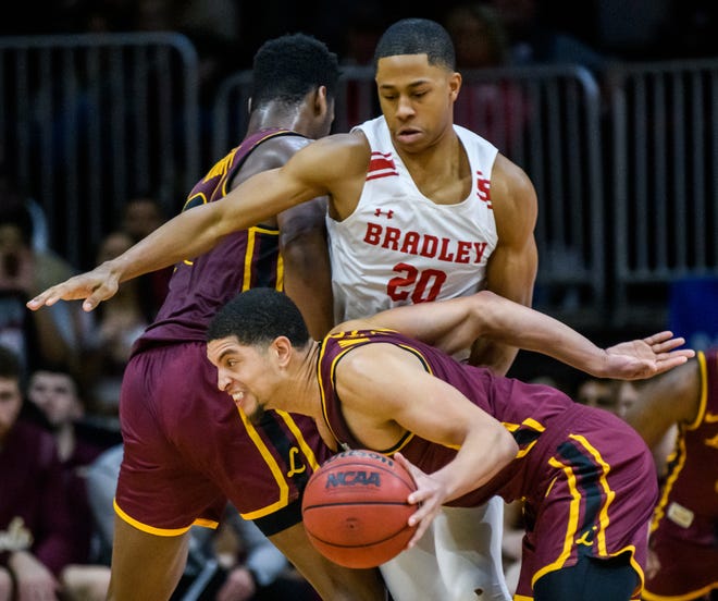 Loyola's Lucas Williamson, foreground, tries to get by Bradley's Jayson Kent in the second half Wednesday, Feb. 9, 2022 at Carver Arena. The Braves defeated the Ramblers 68-61.