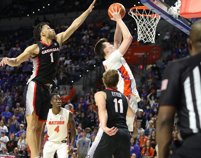 Florida Gators forward Colin Castleton (12) goes up to score at the basket during a basketball game against Georgia at the Exactech Arena in Gainesville Fla. Feb. 9, 2022. The Gators beat the Bulldogs 72-63 to notch another SEC win.