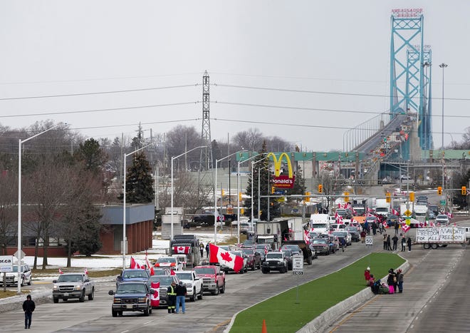 Truckers and supporters block the access leading from the Ambassador Bridge, linking Detroit and Windsor, as truckers and their supporters continue to protest against COVID-19 vaccine mandates and restrictions, in Windsor, Ont. on Feb. 10, 2022.