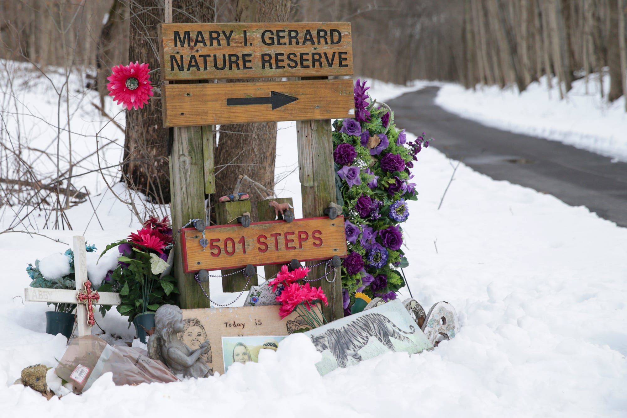 Tokens sit in the snow at a memorial for Abby Williams and Libby German along the Monon High Bridge Trail, Wednesday, Feb. 9, 2022 in Delphi.