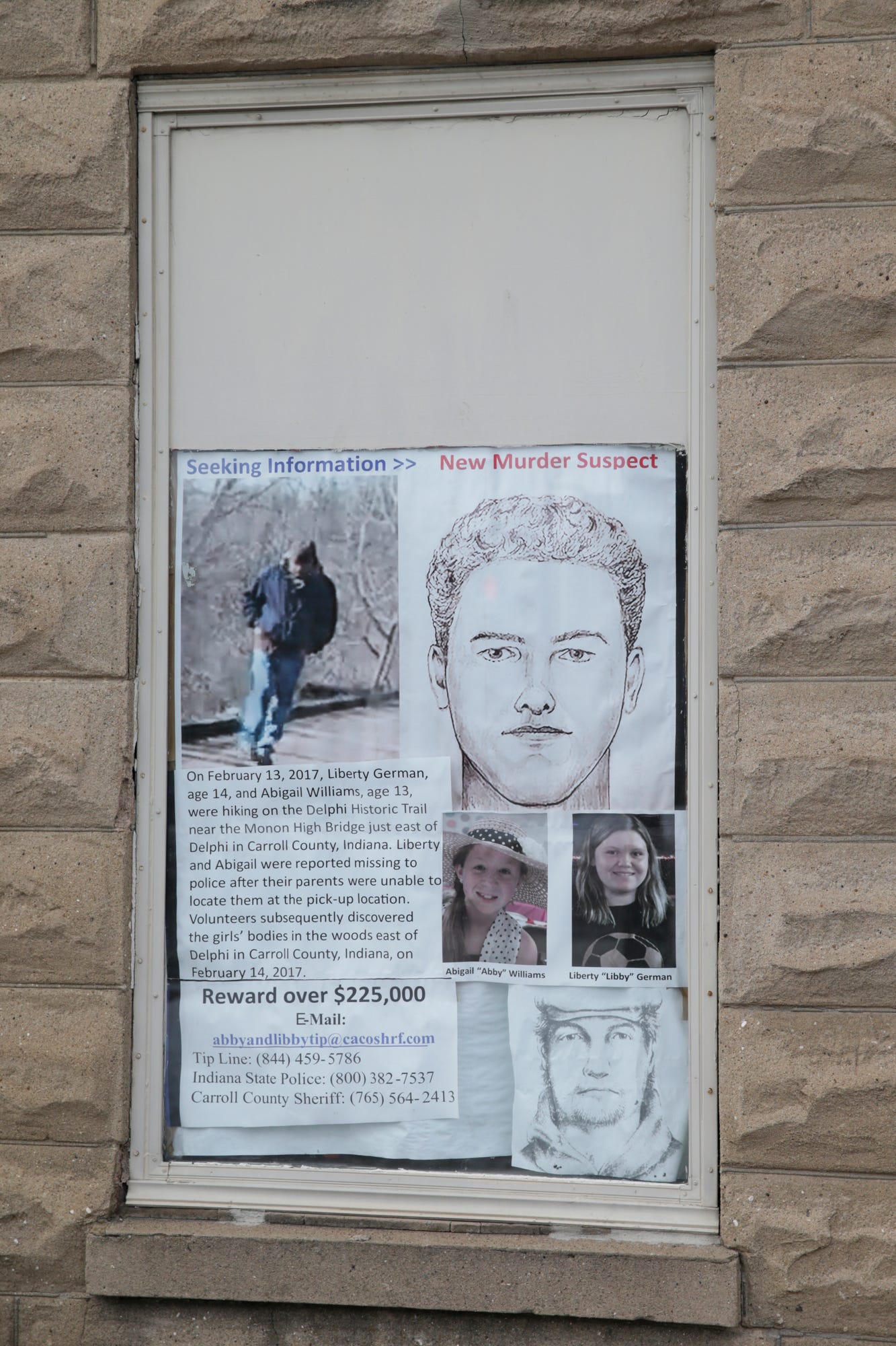 Wanted posters with the latest sketches of the suspected killer of Abby Williams and Libby German hang in the store front of a Main Street business, Wednesday, Feb. 9, 2022 in Delphi.