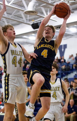Lancaster's Dylan West (4) fights to get in for a lay up against the Teays Valley defense at Teays Valley High School in boys basketball action in Asheville, Ohio on February 9, 2022.