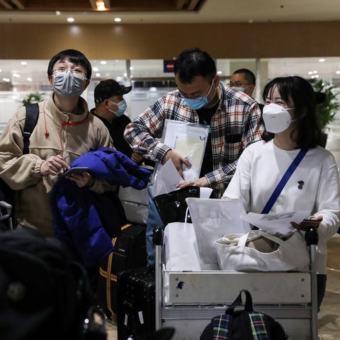 Foreign travelers wear face masks to prevent the s