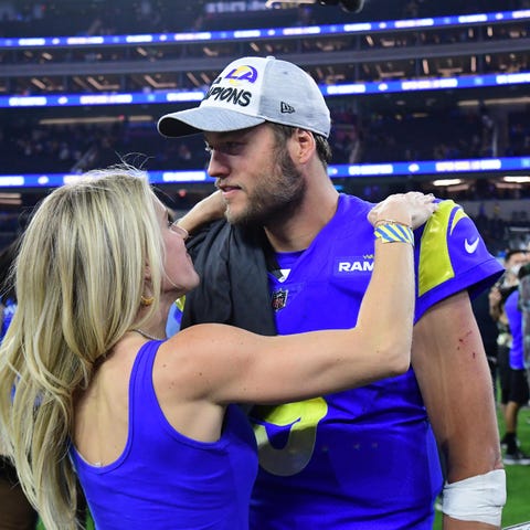Kelly and Matthew Stafford have a moment on the fi