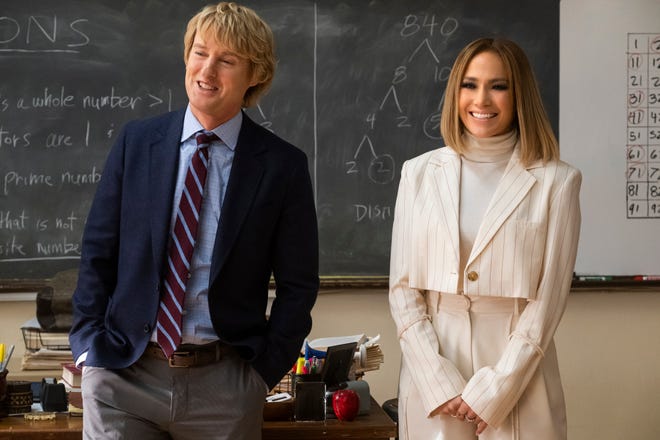 Owen Wilson, left, is mismatched with Jennifer Lopez in her return to rom-coms “Marry Me.”