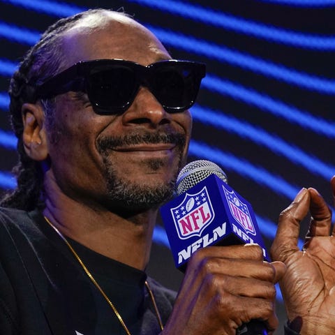 Snoop Dogg answers a question during a news confer