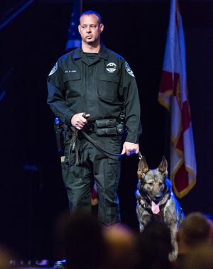 Boynton Beach Officer Mark Sohn pictured in 2016 with his K-9 Daxxx. (Joseph Forzano / The Palm Beach Post)