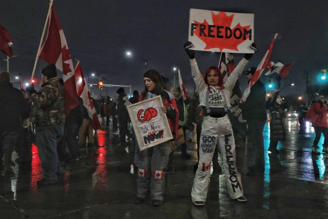 Protesters dance and chant “freedom” during an anti-mandate protest on Huron Church Road in Windsor, ON, on Friday, Feb.11, 2022.