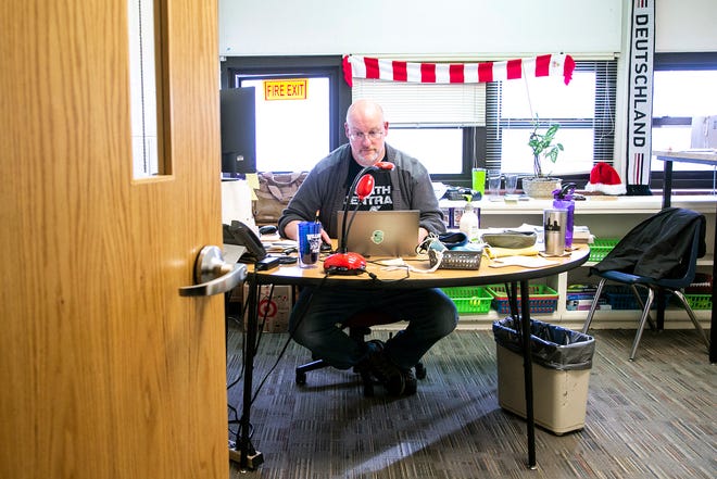 Michael Dankert works at his desk while teaching at the Iowa City school district's Online Program on Friday at the former Hoover Elementary building. Dankert says teaching online classes means he gets to see a lot of his students' dogs, as well.