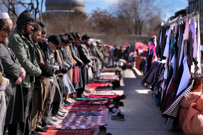 Worshippers pray outside a mosque during the Friday Prayer, in Kabul, Afghanistan, Friday, Feb. 11, 2022. (AP Photo/Hussein Malla) ORG XMIT: XHM105