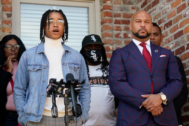 FedEx driver D'Monterrio Gibson, left, stands with family members and one of his attorneys, Carlos Moore, right, as he speaks about his recent experience where he alleges he was fired upon and chased by a white father and son while delivering packages on his route in Brookhaven, at a news conference in Ridgeland, Miss., Thursday, Feb.  10, 2022.