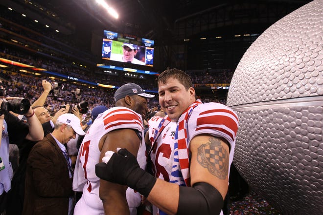 New York Giants guard David Diehl (66), right, celebrates after the Giants beat the Patriots 21-17 in Super Bowl XLVI