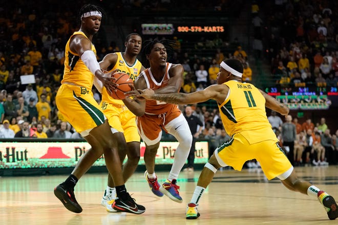 Baylor's Flo Thamba, left, steals the ball from Texas' Marcus Carr last February. The Bears have a six-game winning streak in the series.
