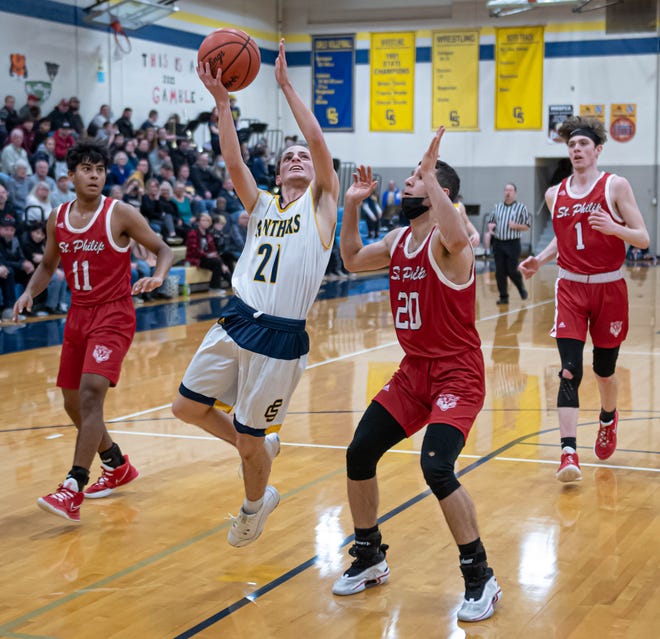 Billy Felton of Climax-Scotts takes his shot as St. Phillip's Chris Adam put defensive pressure during first half action at Climax-Scotts High School on Friday, February 11, 2022.