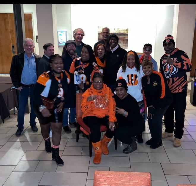 A group of Bengals fans pose with Karen Roseman-Harris (center) in the lobby of a Nashville hotel prior to the AFC Division round game against the Tennessee Titans on Jan. 22, 2022.  Roseman-Harris paid for everyone's trip after the Bengals defeated the Titans 19-16.