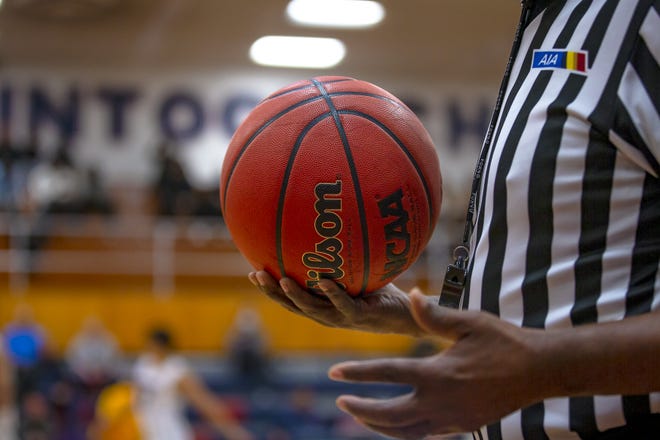 A referee holds the ball just before tipoff during the McClintock Holiday Shootout Championship at McClintock High School in Tempe on Dec. 30, 2021. Monica D. Spencer/The Republic 9049059002