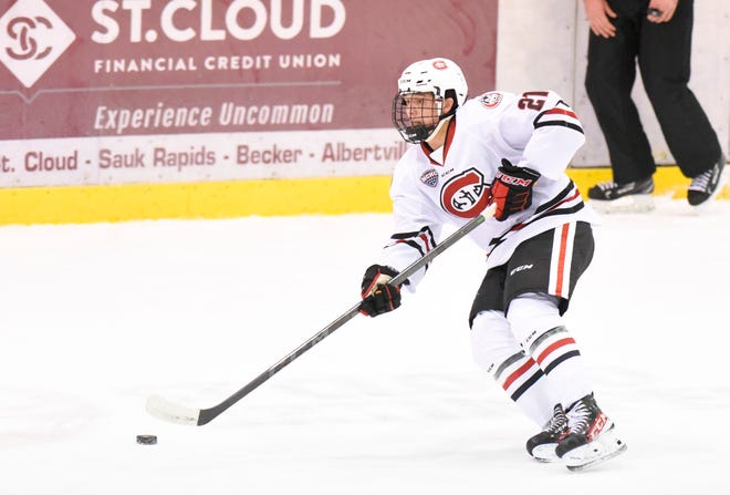 St. Cloud State freshman Josh Luedtke passes the puck Saturday, Feb. 12, 2022, at Herb Brooks National Hockey Center in St. Cloud.