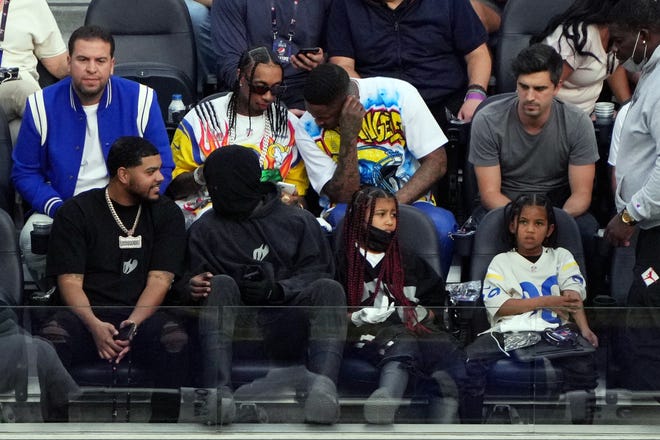 American rapper Kanye West sits with his children North and Saint.