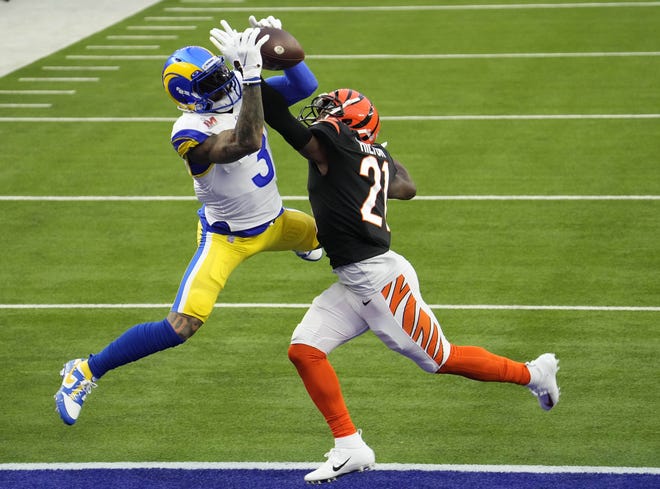 Rams wide receiver Odell Beckham Jr. leaps over Bengals cornerback Mike Hilton to score the first touchdown in Super Bowl 56.