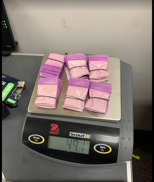 Police say they found nearly 68 packets of heroin wrapped for delivery following the arrest of Kewanee's Willam E. Borsch Friday for charges stemming from a child abuse complaint lodged by Kewanee Dist. 229 school officials.