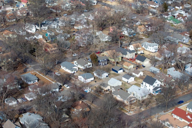 Shawnee County home prices fall as demand remains high. Homes in central Topeka are seen from above.